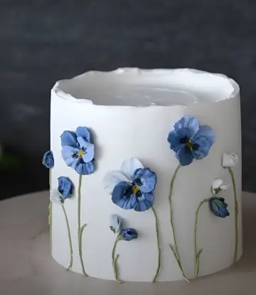 Elegant white cake with blue flowers